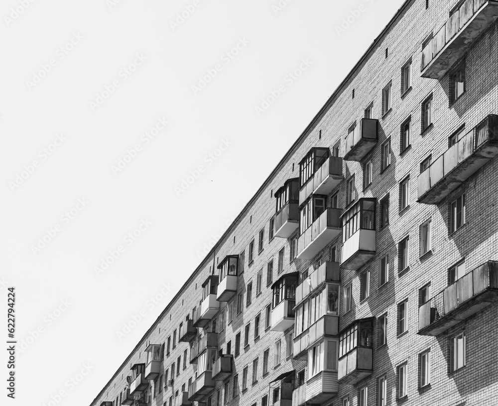 House Colorless Old apartment building with balconies. Colorless, black and white. A ...