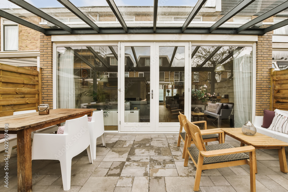 a patio with chairs, tables and an umbrella over the door that leads to a covered area for outdoor dining a patio with chairs, tables and an umbrella over the door that leads to a covered area for outdoor dining