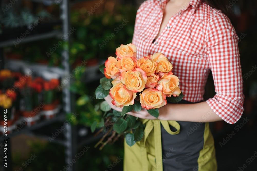 Young beautiful woman florist make bouquet of flowers at flower shop Young beautiful woman florist make bouquet of flowers at flower shop