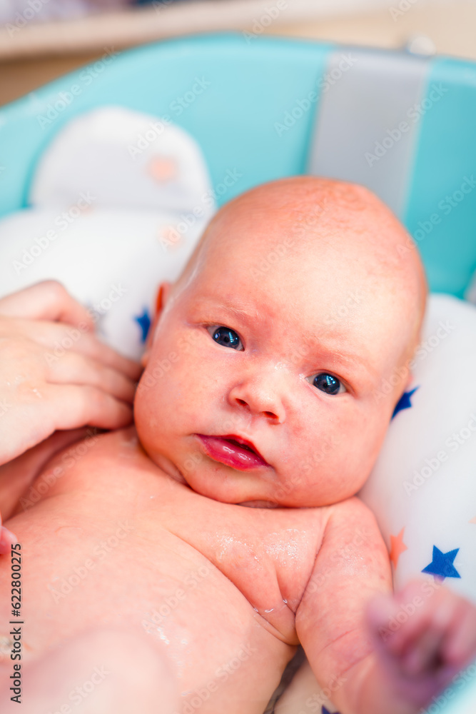 A newborn baby takes a bath. A lovely child is undergoing military training for the first time. The concept of children and hygiene A newborn baby takes a bath. A lovely child is undergoing military training for the first time. The concept of children and hygiene