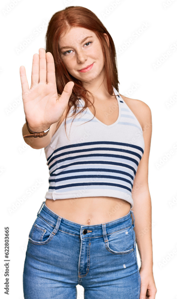 Young read head woman wearing casual clothes doing stop sing with palm of the hand. warning expression with negative and serious gesture on the face. Young read head woman wearing casual clothes doing stop sing with palm of the hand. warning expression with negative and serious gesture on the face.