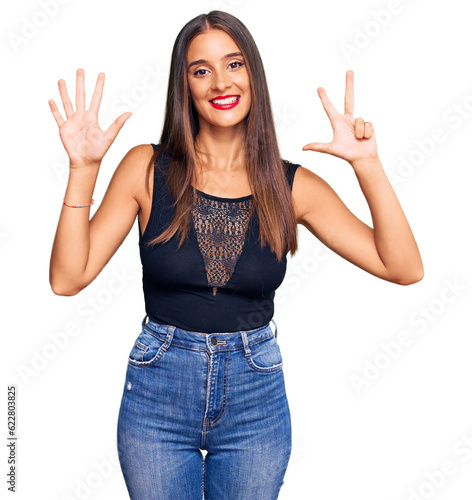 Young hispanic woman wearing casual clothes showing and pointing up with fingers number eight while smiling confident and happy.