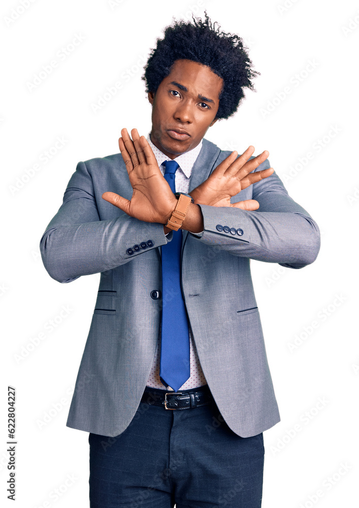 Handsome african american man with afro hair wearing business jacket rejection expression crossing arms doing negative sign, angry face Handsome african american man with afro hair wearing business jacket rejection expression crossing arms doing negative sign, angry face