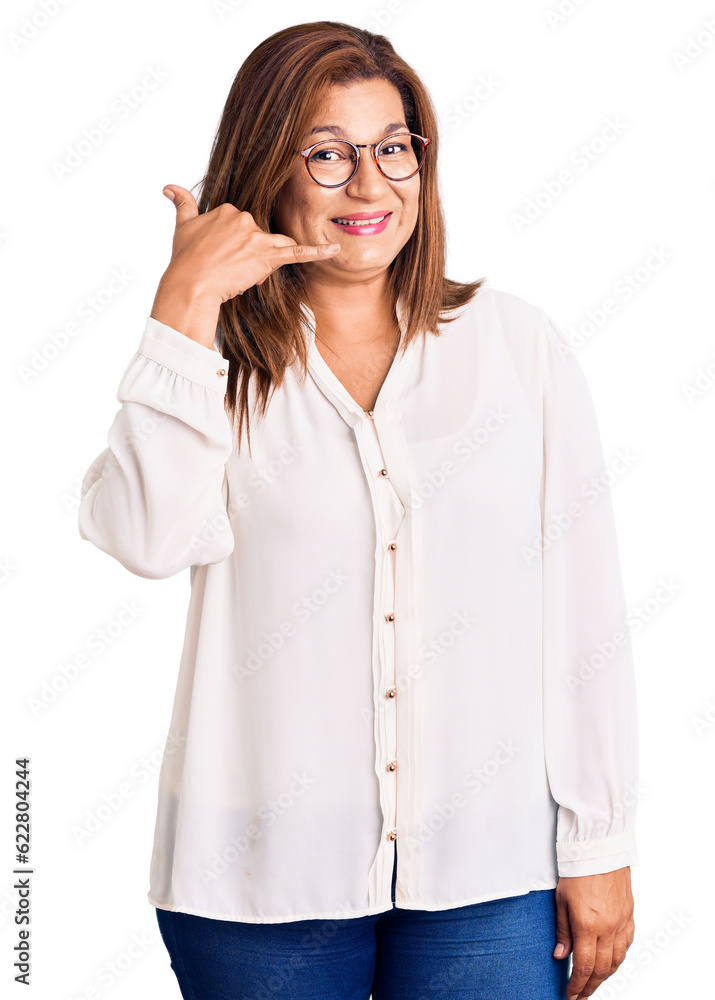 Middle age latin woman wearing casual clothes and glasses smiling doing phone gesture with hand and fingers like talking on the telephone. communicating concepts. Middle age latin woman wearing casual clothes and glasses smiling doing phone gesture with hand and fingers like talking on the telephone. communicating concepts.