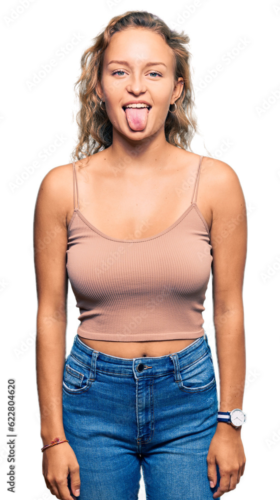 Beautiful caucasian woman wearing casual clothes sticking tongue out happy with funny expression. emotion concept. Beautiful caucasian woman wearing casual clothes sticking tongue out happy with funny expression. emotion concept.