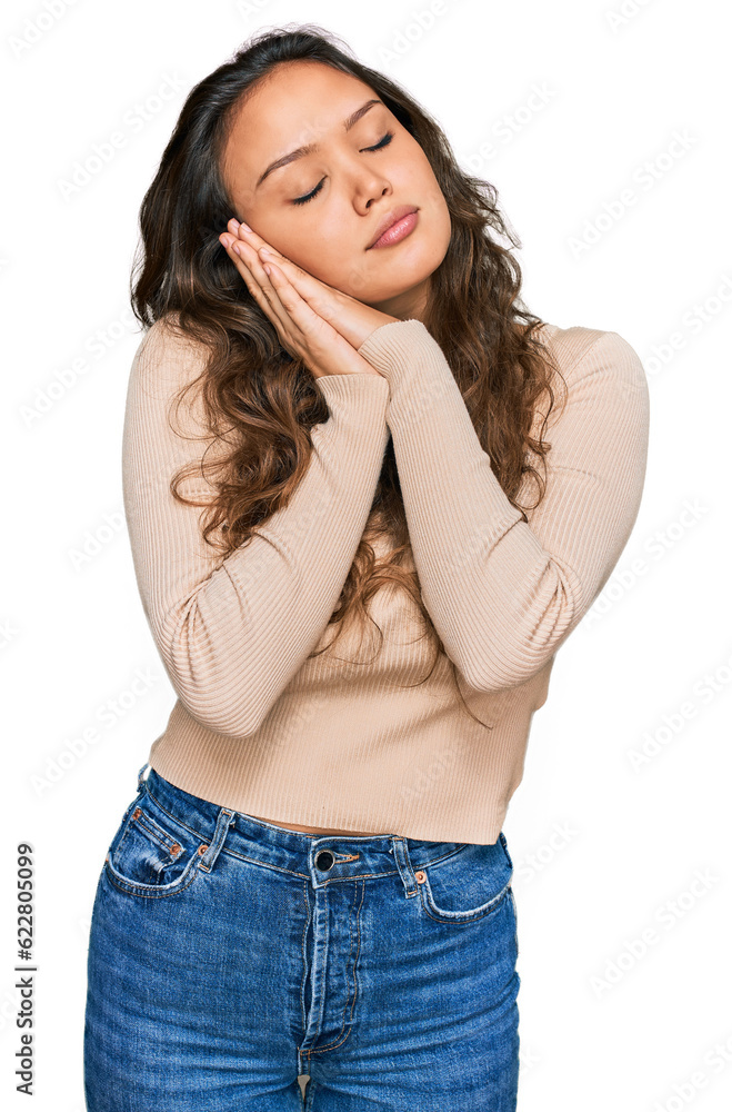 Young hispanic girl wearing casual clothes sleeping tired dreaming and posing with hands together while smiling with closed eyes. Young hispanic girl wearing casual clothes sleeping tired dreaming and posing with hands together while smiling with closed eyes.