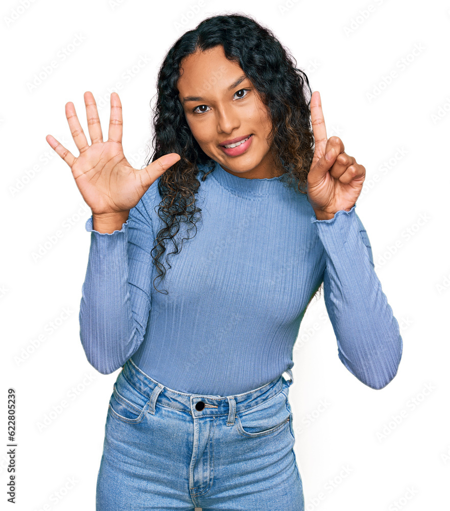 Young hispanic woman with curly hair wearing casual clothes showing and pointing up with fingers number six while smiling confident and happy. Young hispanic woman with curly hair wearing casual clothes showing and pointing up with fingers number six while smiling confident and happy.
