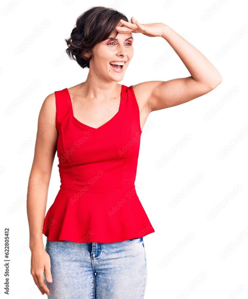 Beautiful young woman with short hair wearing casual style with sleeveless shirt very happy and smiling looking far away with hand over head. searching concept. Beautiful young woman with short hair wearing casual style with sleeveless shirt very happy and smiling looking far away with hand over head. searching concept.