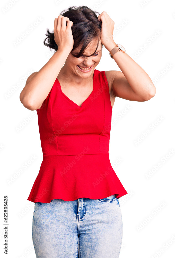 Beautiful young woman with short hair wearing casual style with sleeveless shirt suffering from headache desperate and stressed because pain and migraine. hands on head. Beautiful young woman with short hair wearing casual style with sleeveless shirt suffering from headache desperate and stressed because pain and migraine. hands on head.