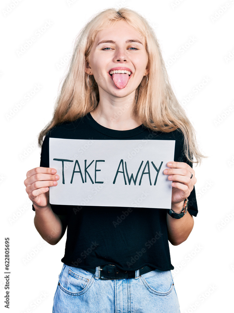 Young caucasian woman holding banner with take away message sticking tongue out happy with funny expression. Young caucasian woman holding banner with take away message sticking tongue out happy with funny expression.