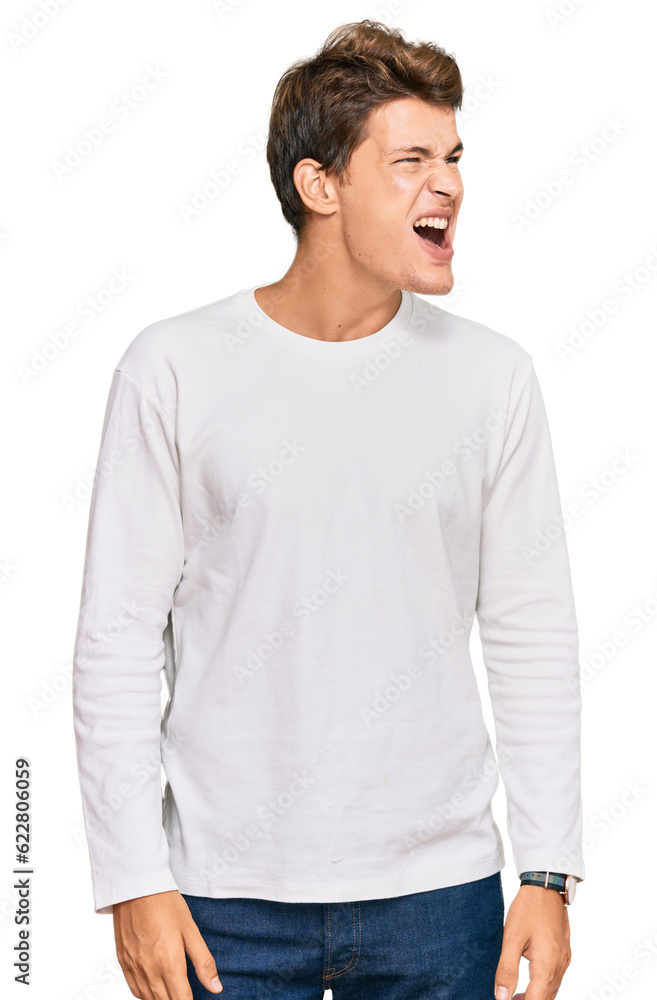Handsome caucasian man wearing casual white sweater angry and mad screaming frustrated and furious, shouting with anger. rage and aggressive concept. Handsome caucasian man wearing casual white sweater angry and mad screaming frustrated and furious, shouting with anger. rage and aggressive concept.