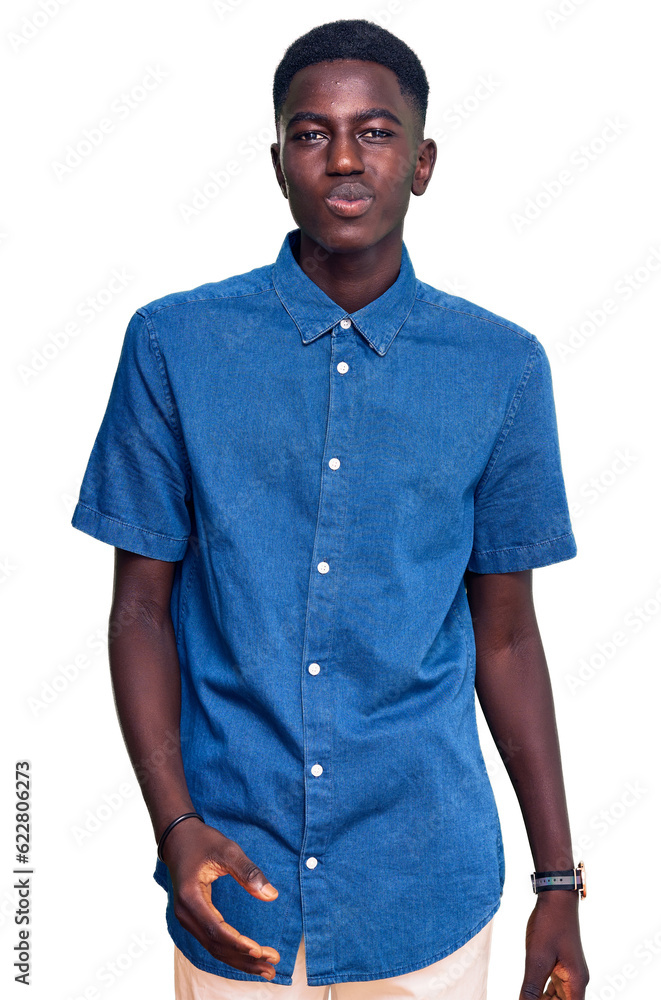 Fototapeta premium Young african american man wearing casual clothes looking at the camera blowing a kiss on air being lovely and sexy. love expression.