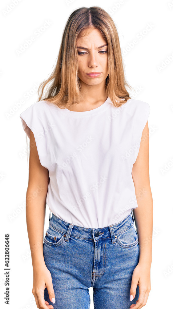 Beautiful caucasian woman with blonde hair wearing casual white tshirt depressed and worry for distress, crying angry and afraid. sad expression. Beautiful caucasian woman with blonde hair wearing casual white tshirt depressed and worry for distress, crying angry and afraid. sad expression.