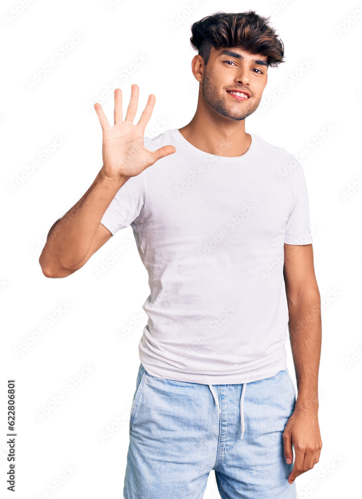 Young hispanic man wearing casual clothes showing and pointing up with fingers number five while smiling confident and happy. Young hispanic man wearing casual clothes showing and pointing up with fingers number five while smiling confident and happy.