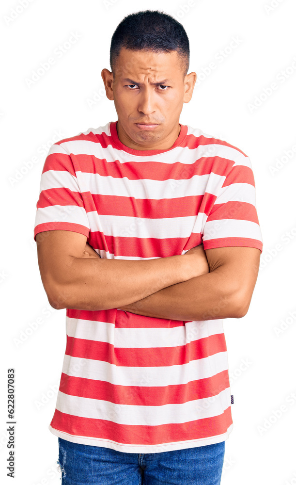 Young handsome latin man wearing casual clothes skeptic and nervous, disapproving expression on face with crossed arms. negative person. Young handsome latin man wearing casual clothes skeptic and nervous, disapproving expression on face with crossed arms. negative person.