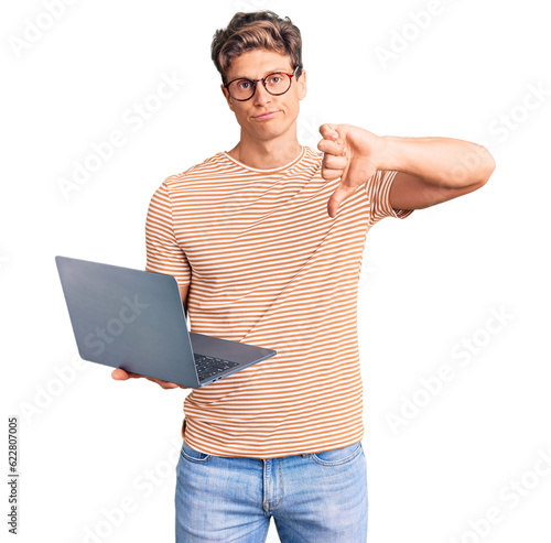Canvastavla Young handsome man wearing glasses holding laptop with angry face, negative sign