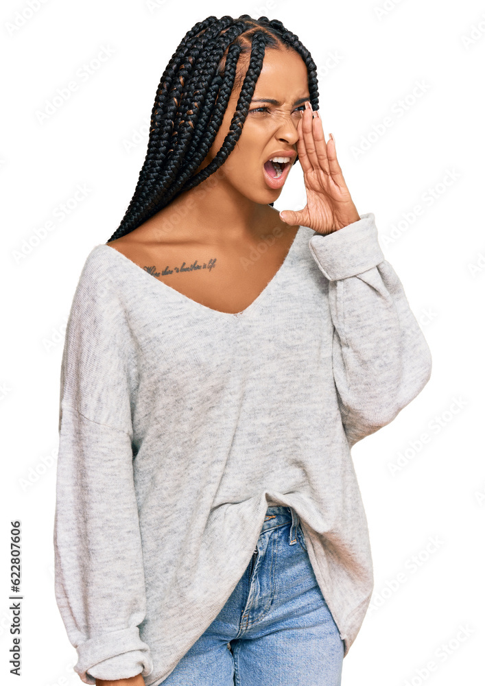 Beautiful hispanic woman wearing casual clothes shouting and screaming loud to side with hand on mouth. communication concept. Beautiful hispanic woman wearing casual clothes shouting and screaming loud to side with hand on mouth. communication concept.
