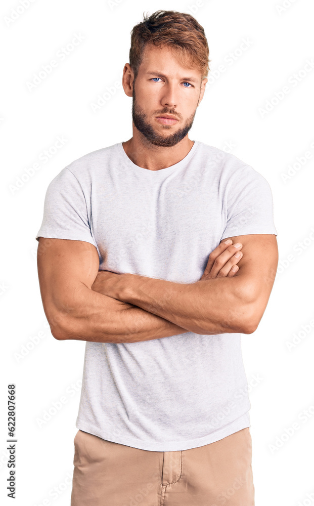 Young caucasian man wearing casual white tshirt skeptic and nervous, disapproving expression on face with crossed arms. negative person. Young caucasian man wearing casual white tshirt skeptic and nervous, disapproving expression on face with crossed arms. negative person.
