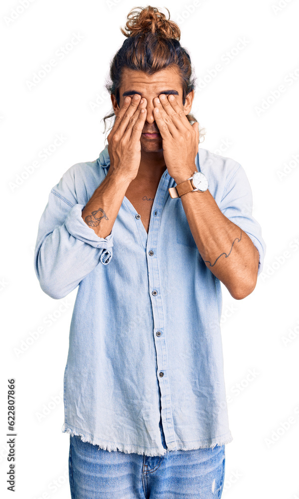 Young hispanic man wearing summer style rubbing eyes for fatigue and headache, sleepy and tired expression. vision problem Young hispanic man wearing summer style rubbing eyes for fatigue and headache, sleepy and tired expression. vision problem