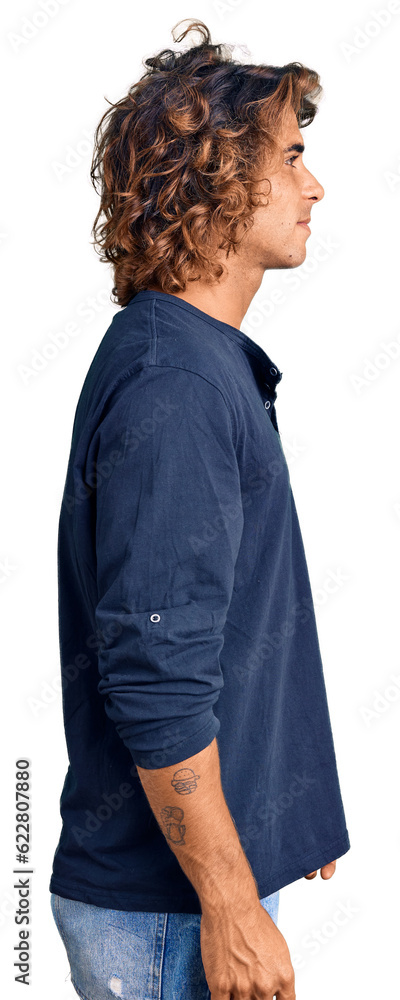 Young hispanic man wearing casual clothes looking to side, relax profile pose with natural face with confident smile. Young hispanic man wearing casual clothes looking to side, relax profile pose with natural face with confident smile.