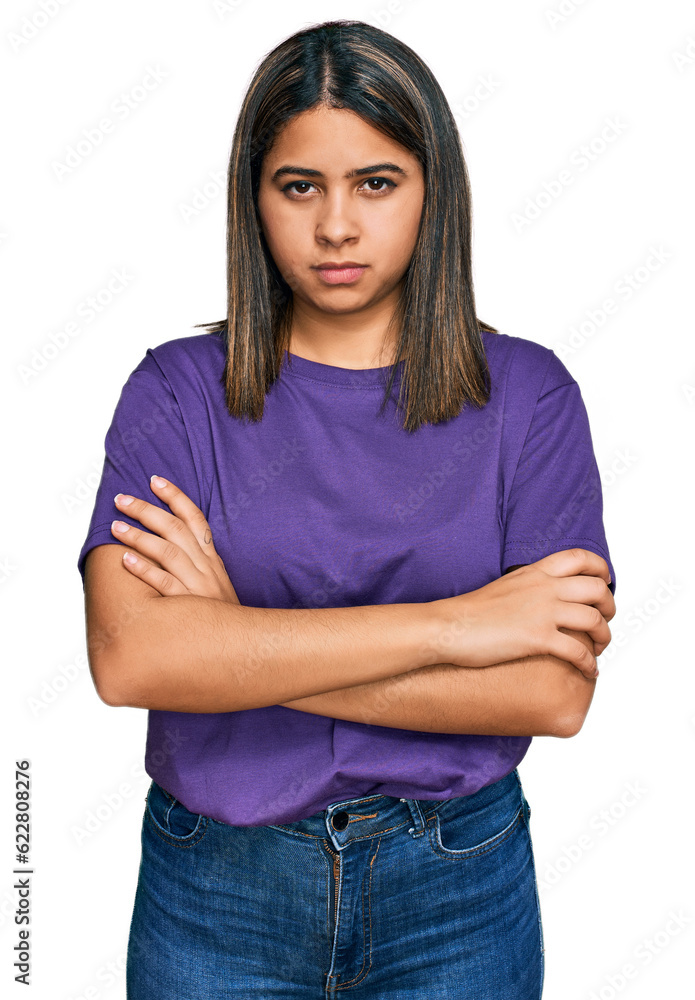 Young hispanic girl wearing casual purple t shirt skeptic and nervous, disapproving expression on face with crossed arms. negative person. Young hispanic girl wearing casual purple t shirt skeptic and nervous, disapproving expression on face with crossed arms. negative person.