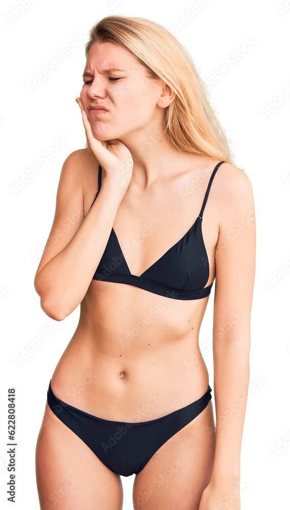 Naklejka premium Young beautiful blonde woman wearing bikini touching mouth with hand with painful expression because of toothache or dental illness on teeth. dentist