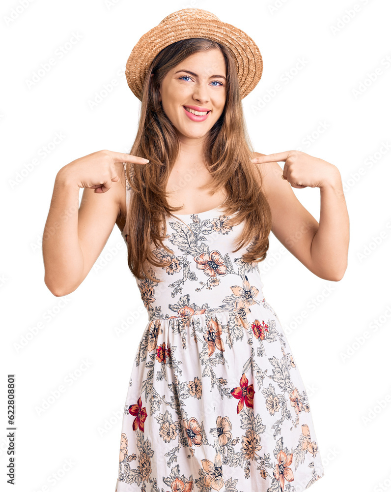 Beautiful caucasian young woman wearing summer hat looking confident with smile on face, pointing oneself with fingers proud and happy. Beautiful caucasian young woman wearing summer hat looking confident with smile on face, pointing oneself with fingers proud and happy.