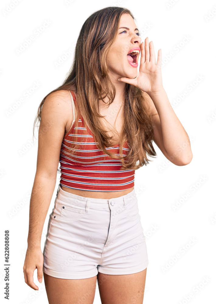 Beautiful caucasian young woman wearing casual clothes shouting and screaming loud to side with hand on mouth. communication concept. Beautiful caucasian young woman wearing casual clothes shouting and screaming loud to side with hand on mouth. communication concept.