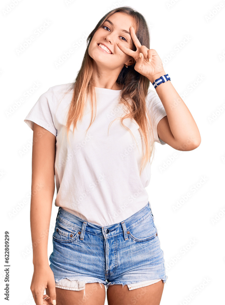 Beautiful caucasian woman wearing casual white tshirt doing peace symbol with fingers over face, smiling cheerful showing victory Beautiful caucasian woman wearing casual white tshirt doing peace symbol with fingers over face, smiling cheerful showing victory