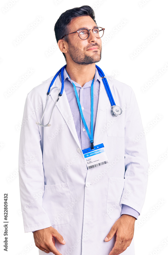 Young hispanic man wearing doctor uniform and stethoscope smiling looking to the side and staring away thinking. Young hispanic man wearing doctor uniform and stethoscope smiling looking to the side and staring away thinking.