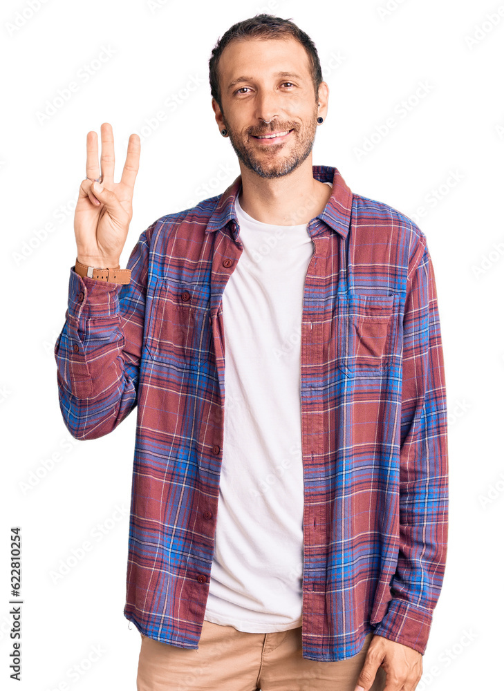 Young handsome man wearing casual clothes showing and pointing up with fingers number three while smiling confident and happy. Young handsome man wearing casual clothes showing and pointing up with fingers number three while smiling confident and happy.