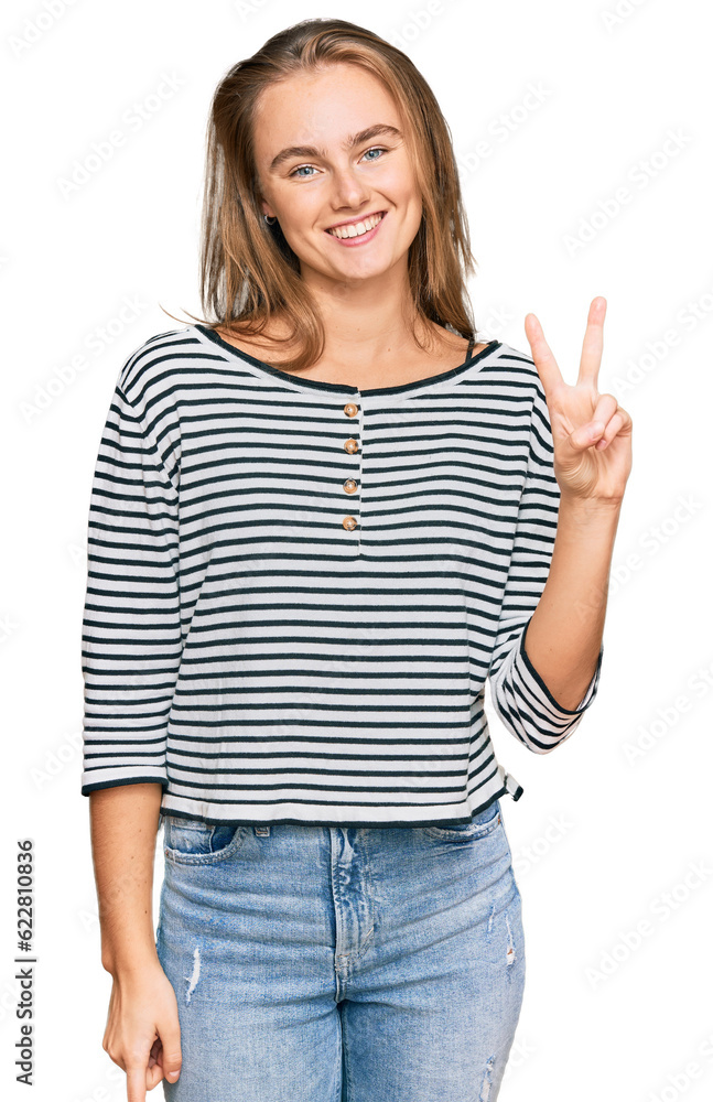 Beautiful blonde woman wearing casual clothes showing and pointing up with fingers number two while smiling confident and happy. Beautiful blonde woman wearing casual clothes showing and pointing up with fingers number two while smiling confident and happy.