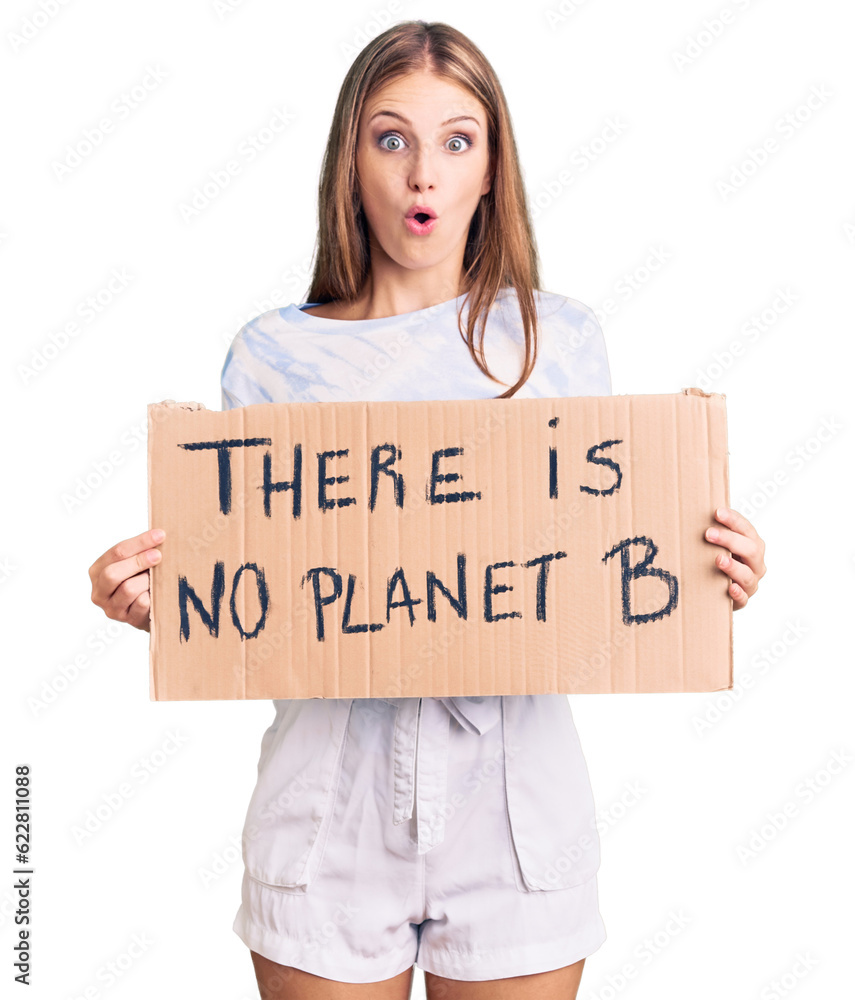 Young beautiful blonde woman holding there is no planet b banner scared and amazed with open mouth for surprise, disbelief face Young beautiful blonde woman holding there is no planet b banner scared and amazed with open mouth for surprise, disbelief face