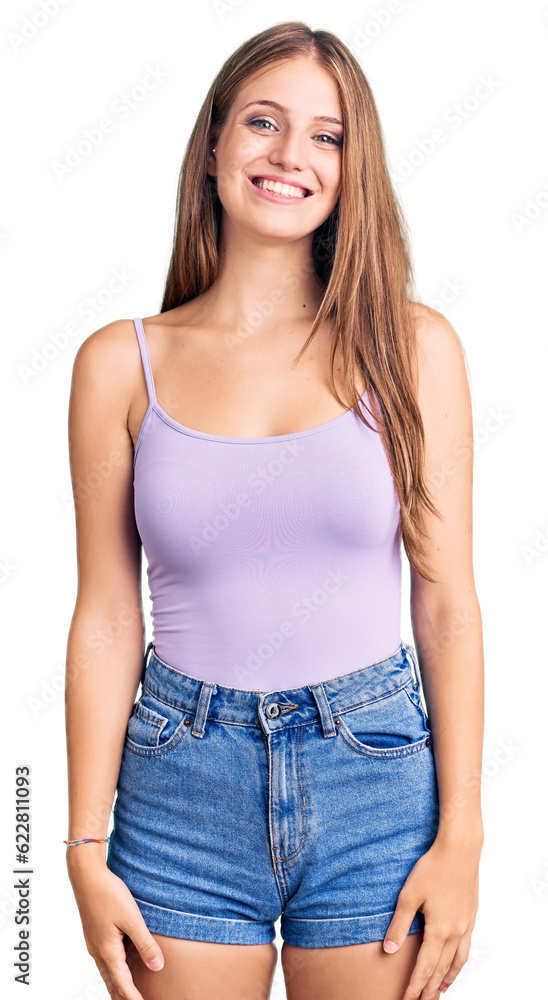 Young beautiful blonde woman wearing casual style with sleeveless shirt looking positive and happy standing and smiling with a confident smile showing teeth Young beautiful blonde woman wearing casual style with sleeveless shirt looking positive and happy standing and smiling with a confident smile showing teeth