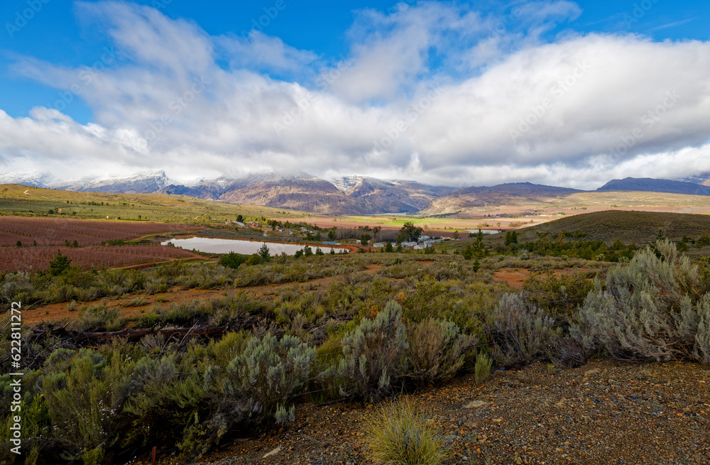 Naklejka premium A panoramic view over a winter landscape with blue skies near Ceres, Western Cape, South Africa.