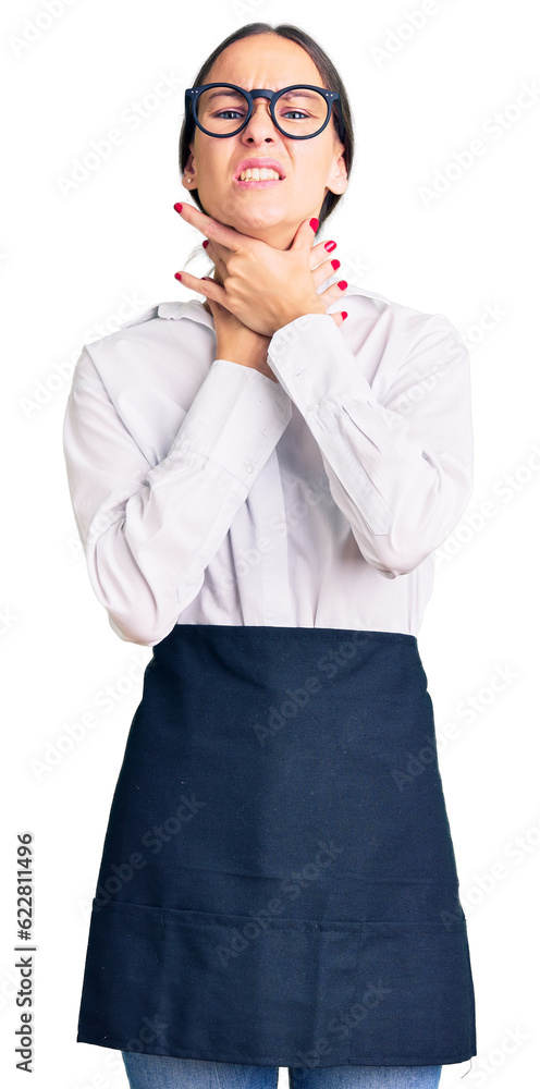 Beautiful brunette young woman wearing professional waitress apron shouting suffocate because painful strangle. health problem. asphyxiate and suicide concept. Beautiful brunette young woman wearing professional waitress apron shouting suffocate because painful strangle. health problem. asphyxiate and suicide concept.