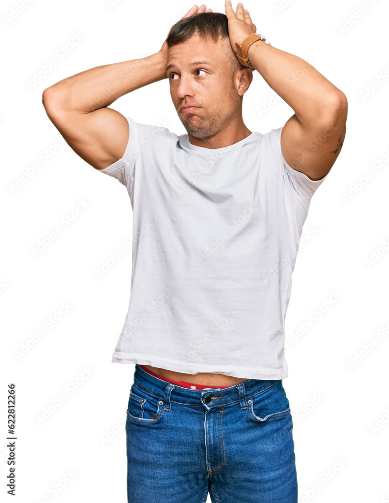 Handsome muscle man wearing casual white tshirt doing bunny ears gesture with hands palms looking cynical and skeptical. easter rabbit concept. Handsome muscle man wearing casual white tshirt doing bunny ears gesture with hands palms looking cynical and skeptical. easter rabbit concept.