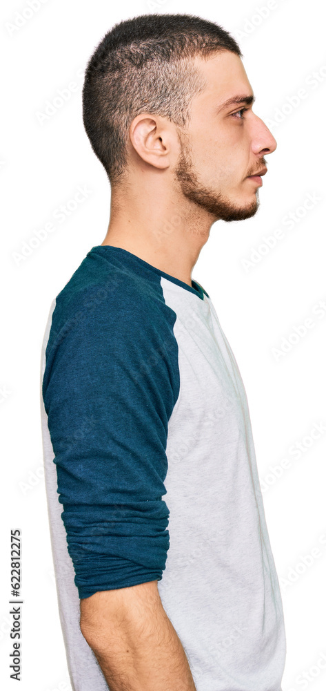 Hispanic young man wearing casual clothes looking to side, relax profile pose with natural face with confident smile. Hispanic young man wearing casual clothes looking to side, relax profile pose with natural face with confident smile.