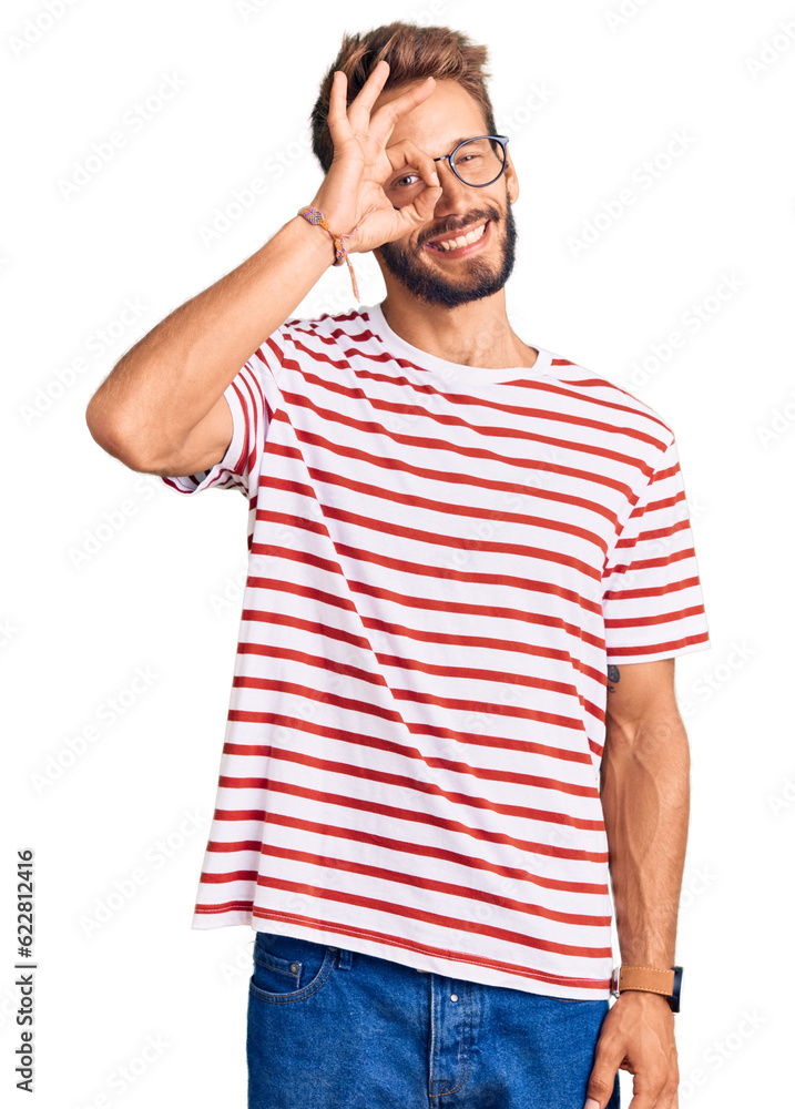 Handsome blond man with beard wearing casual clothes and glasses doing ok gesture with hand smiling, eye looking through fingers with happy face. Handsome blond man with beard wearing casual clothes and glasses doing ok gesture with hand smiling, eye looking through fingers with happy face.