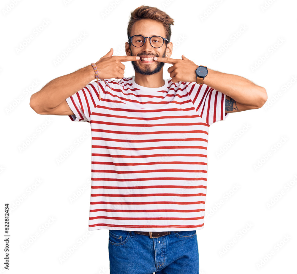 Fototapeta premium Handsome blond man with beard wearing casual clothes and glasses smiling cheerful showing and pointing with fingers teeth and mouth. dental health concept.