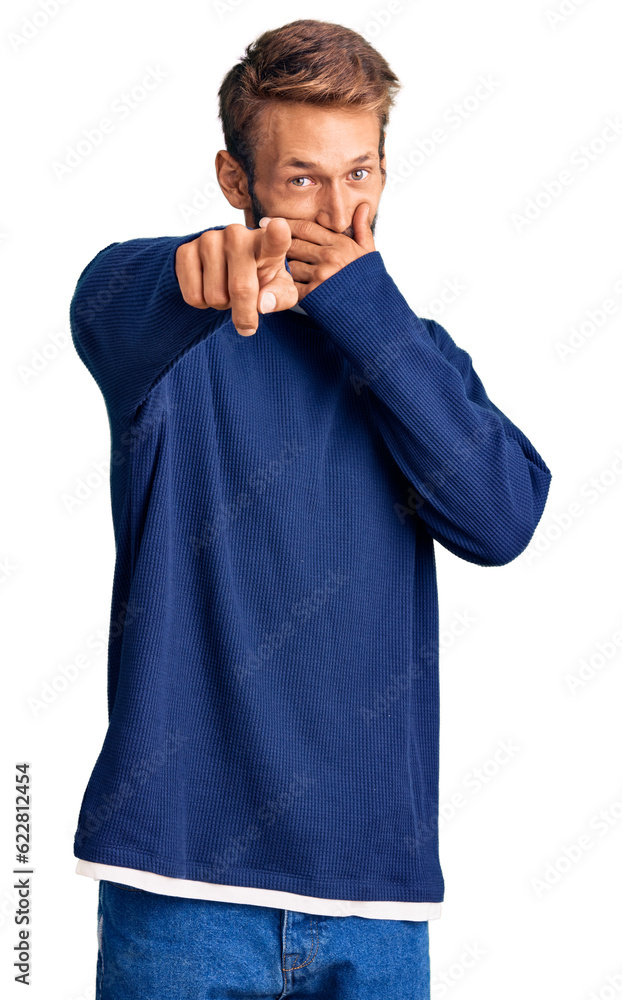 Handsome blond man with beard wearing casual sweater laughing at you, pointing finger to the camera with hand over mouth, shame expression Handsome blond man with beard wearing casual sweater laughing at you, pointing finger to the camera with hand over mouth, shame expression