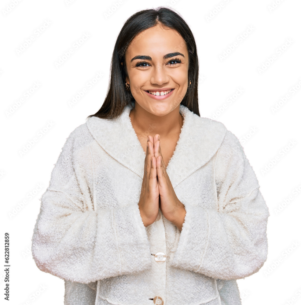 Young brunette woman wearing casual clothes praying with hands together asking for forgiveness smiling confident. Young brunette woman wearing casual clothes praying with hands together asking for forgiveness smiling confident.