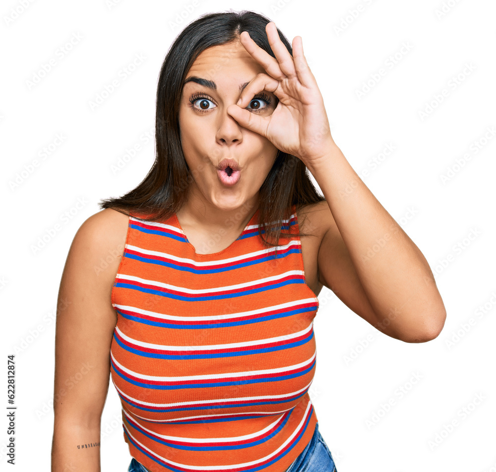 Young brunette woman wearing casual clothes doing ok gesture shocked with surprised face, eye looking through fingers. unbelieving expression. Young brunette woman wearing casual clothes doing ok gesture shocked with surprised face, eye looking through fingers. unbelieving expression.