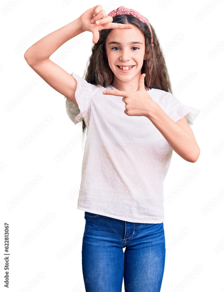 Cute hispanic child girl wearing casual white tshirt smiling making frame with hands and fingers with happy face. creativity and photography concept. Cute hispanic child girl wearing casual white tshirt smiling making frame with hands and fingers with happy face. creativity and photography concept.