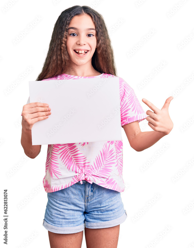 Cute hispanic child girl holding blank empty banner smiling happy pointing with hand and finger Cute hispanic child girl holding blank empty banner smiling happy pointing with hand and finger