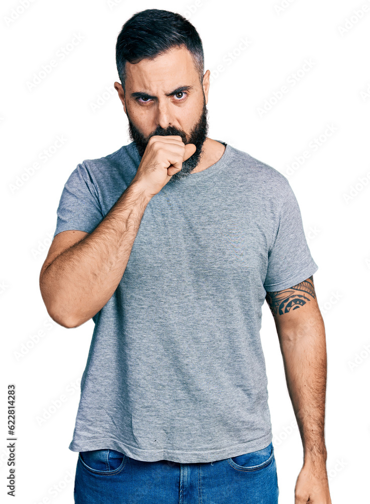 Hispanic man with beard wearing casual grey t shirt feeling unwell and coughing as symptom for cold or bronchitis. health care concept. Hispanic man with beard wearing casual grey t shirt feeling unwell and coughing as symptom for cold or bronchitis. health care concept.