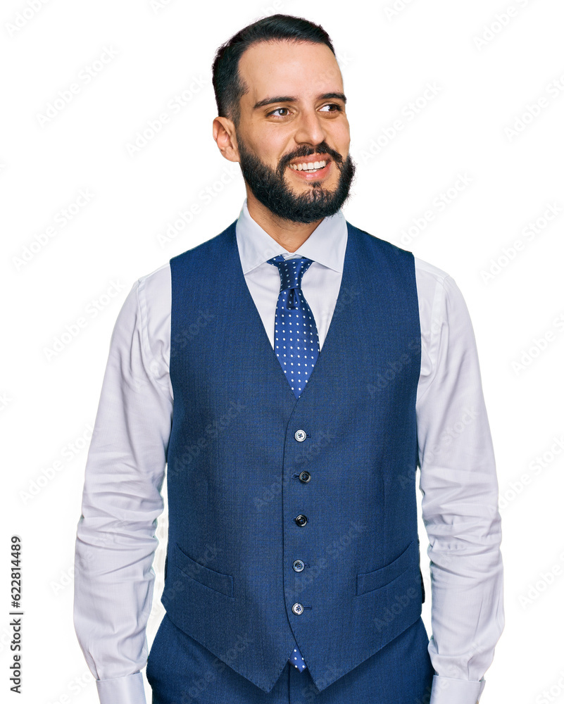 Young man with beard wearing business vest looking away to side with smile on face, natural expression. laughing confident. Young man with beard wearing business vest looking away to side with smile on face, natural expression. laughing confident.