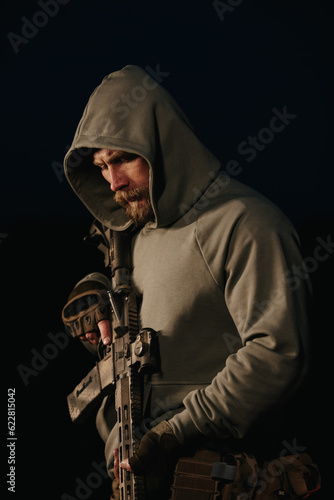 Ukrainian defender with his weapon on a black background