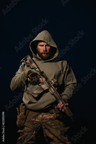 Portrait of Ukrainian defender holding rifle