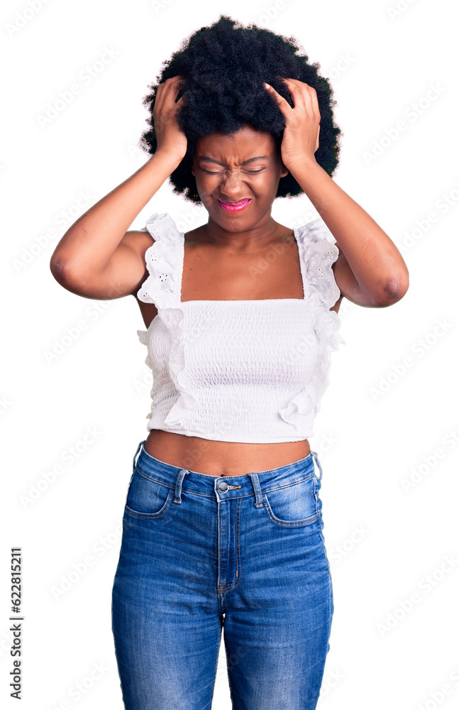 Young african american woman wearing casual clothes suffering from headache desperate and stressed because pain and migraine. hands on head. Young african american woman wearing casual clothes suffering from headache desperate and stressed because pain and migraine. hands on head.